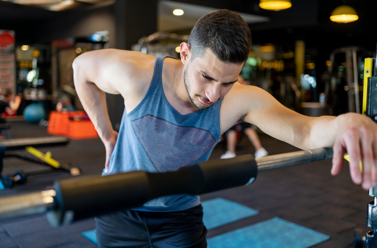 Man with lower back pain at the gym